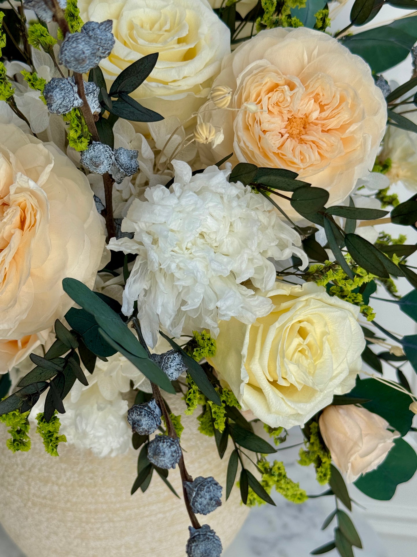 Ivory and blush eternal roses in ceramic vase