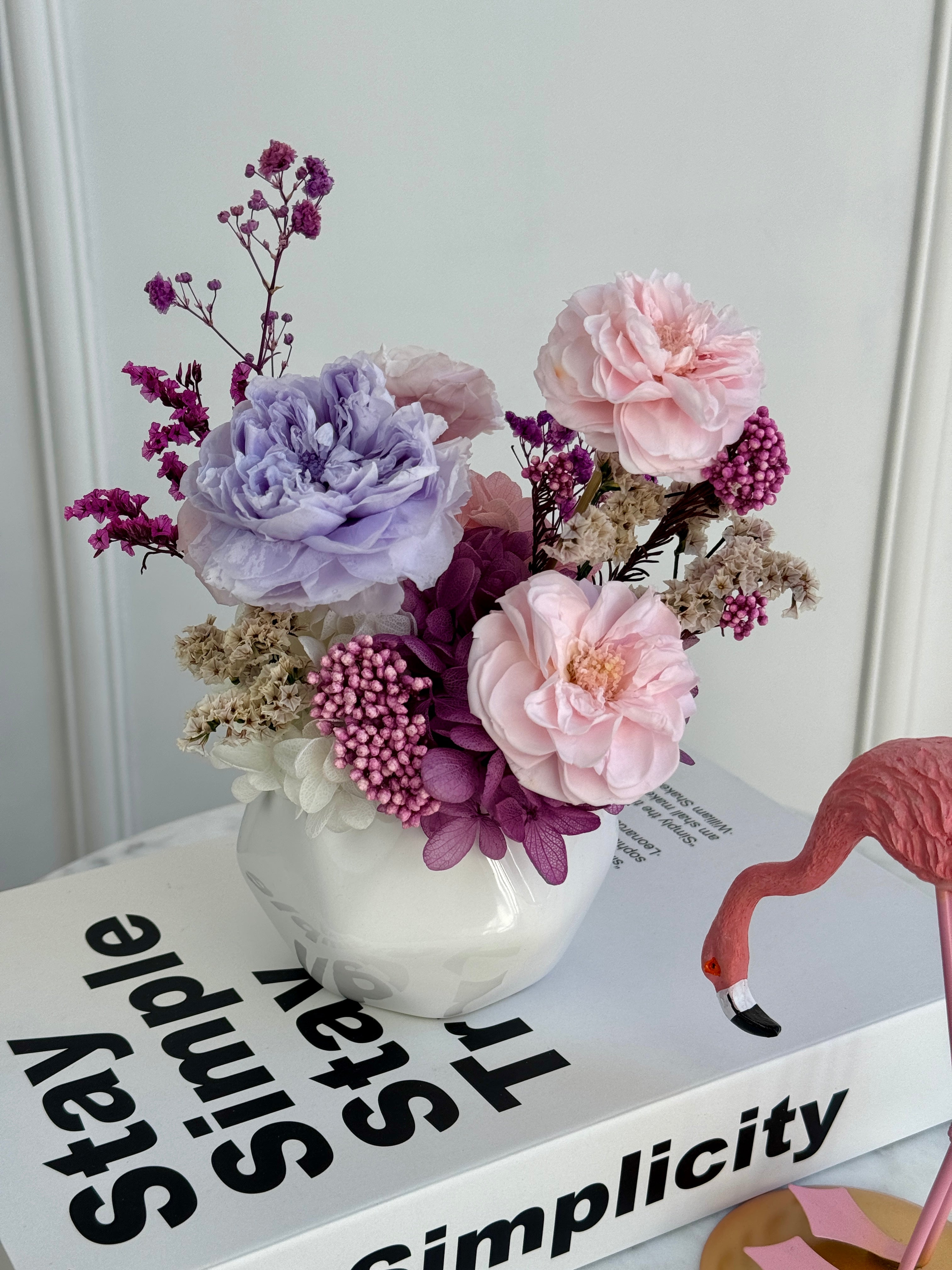 Elegant long-lasting preserved flowers centerpiece with berry accents and ceramic vase