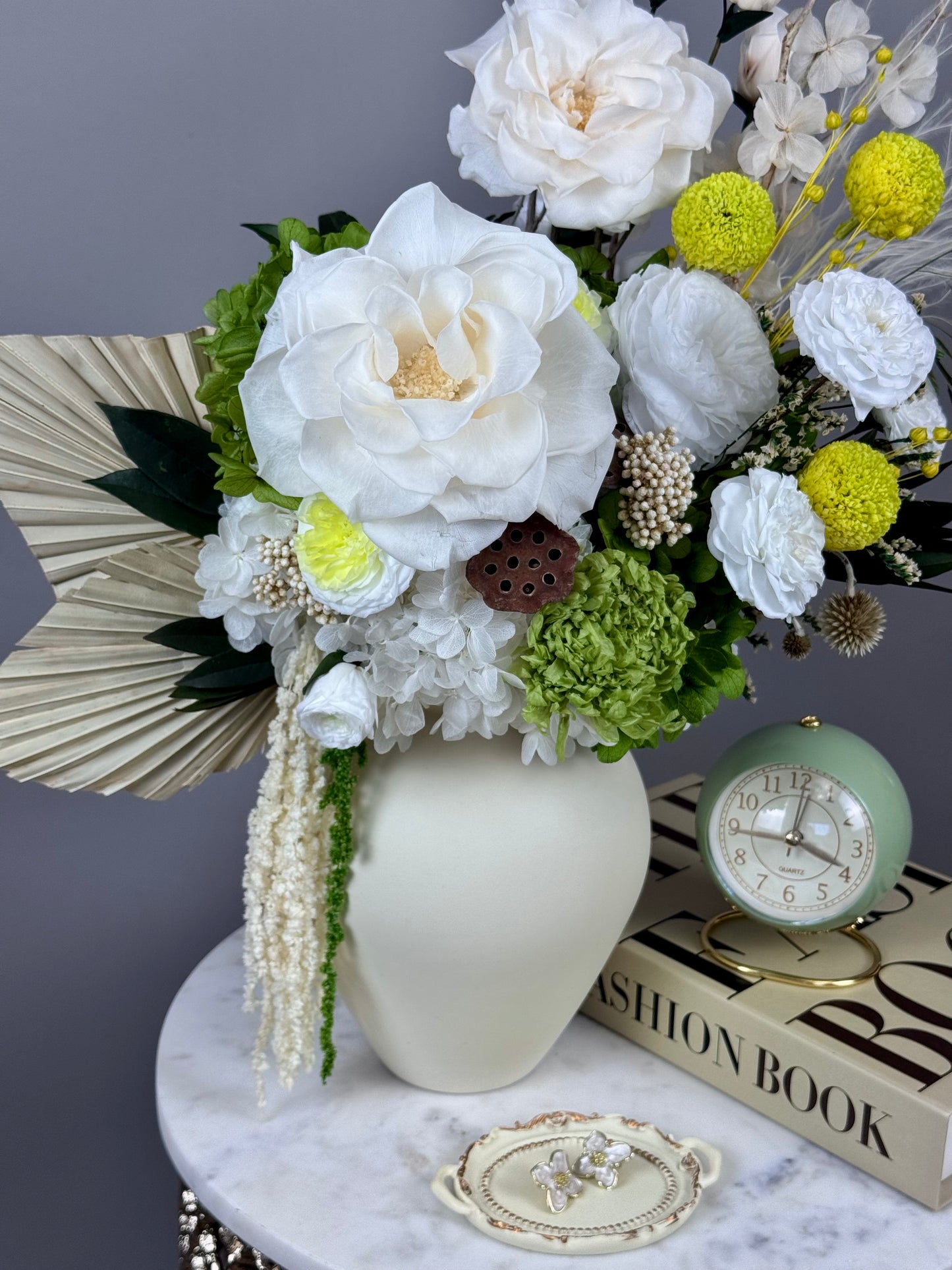 Soft pistachio-tone preserved roses in ceramic vase