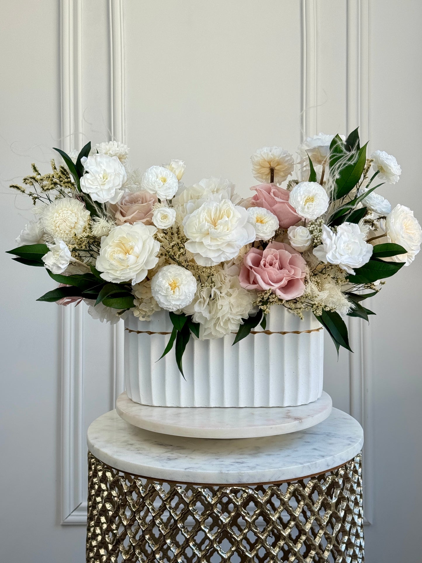 Ivory preserved roses and dahlias in ceramic vase