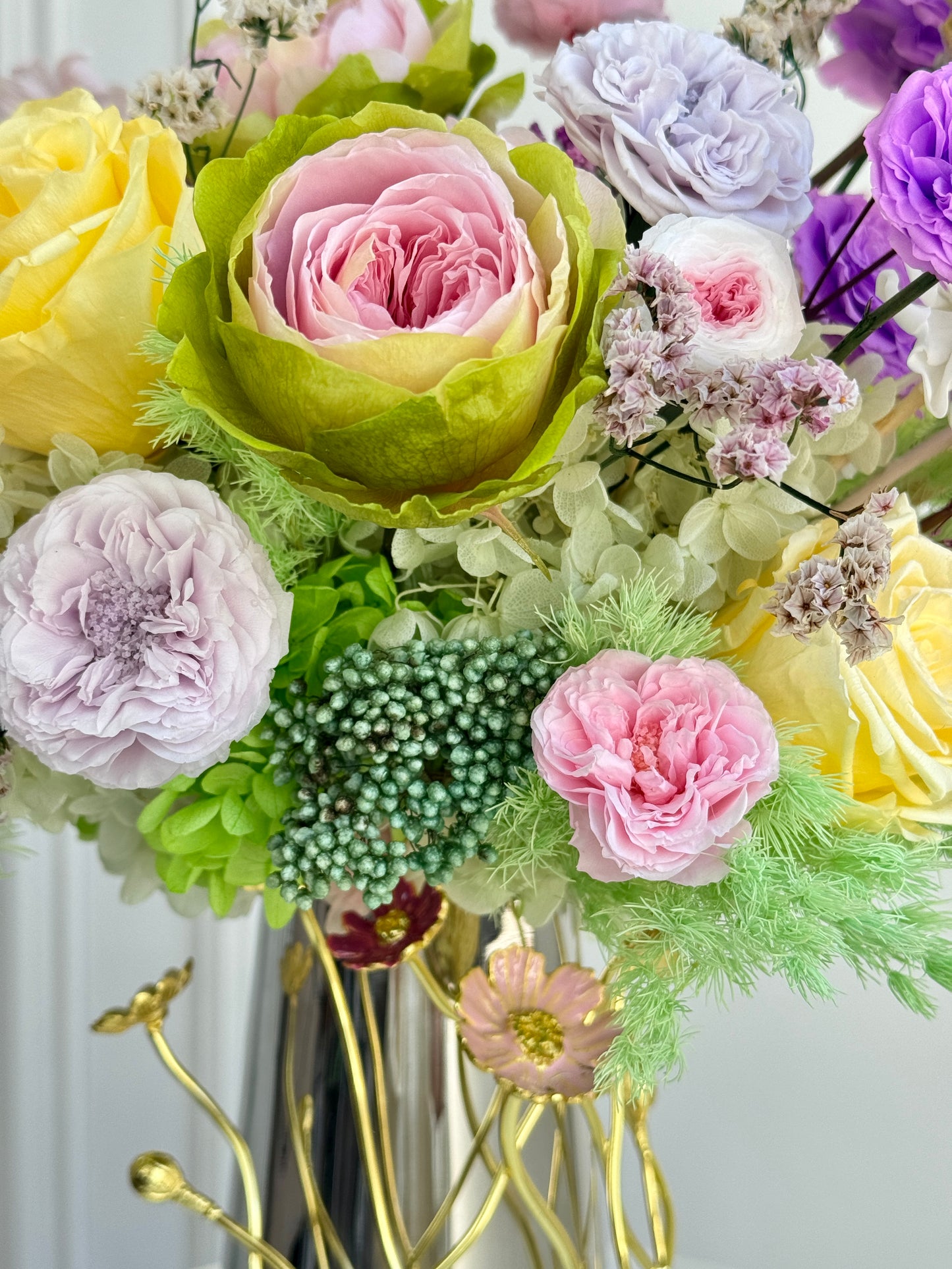 Layered colorful blooms in preserved arrangement