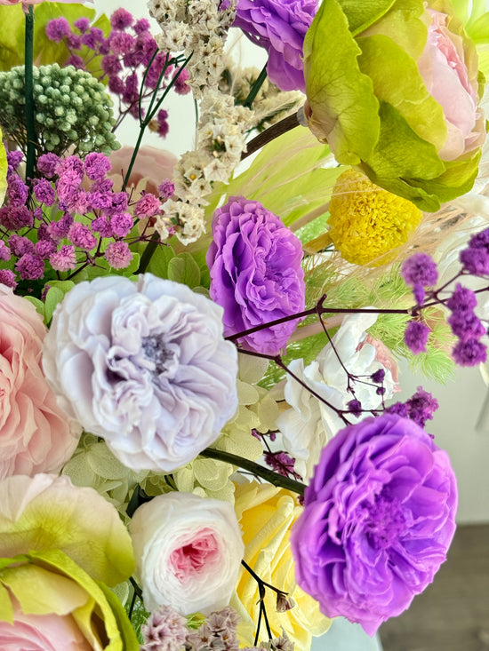 Side view of Vivid Bloom Burst preserved arrangement