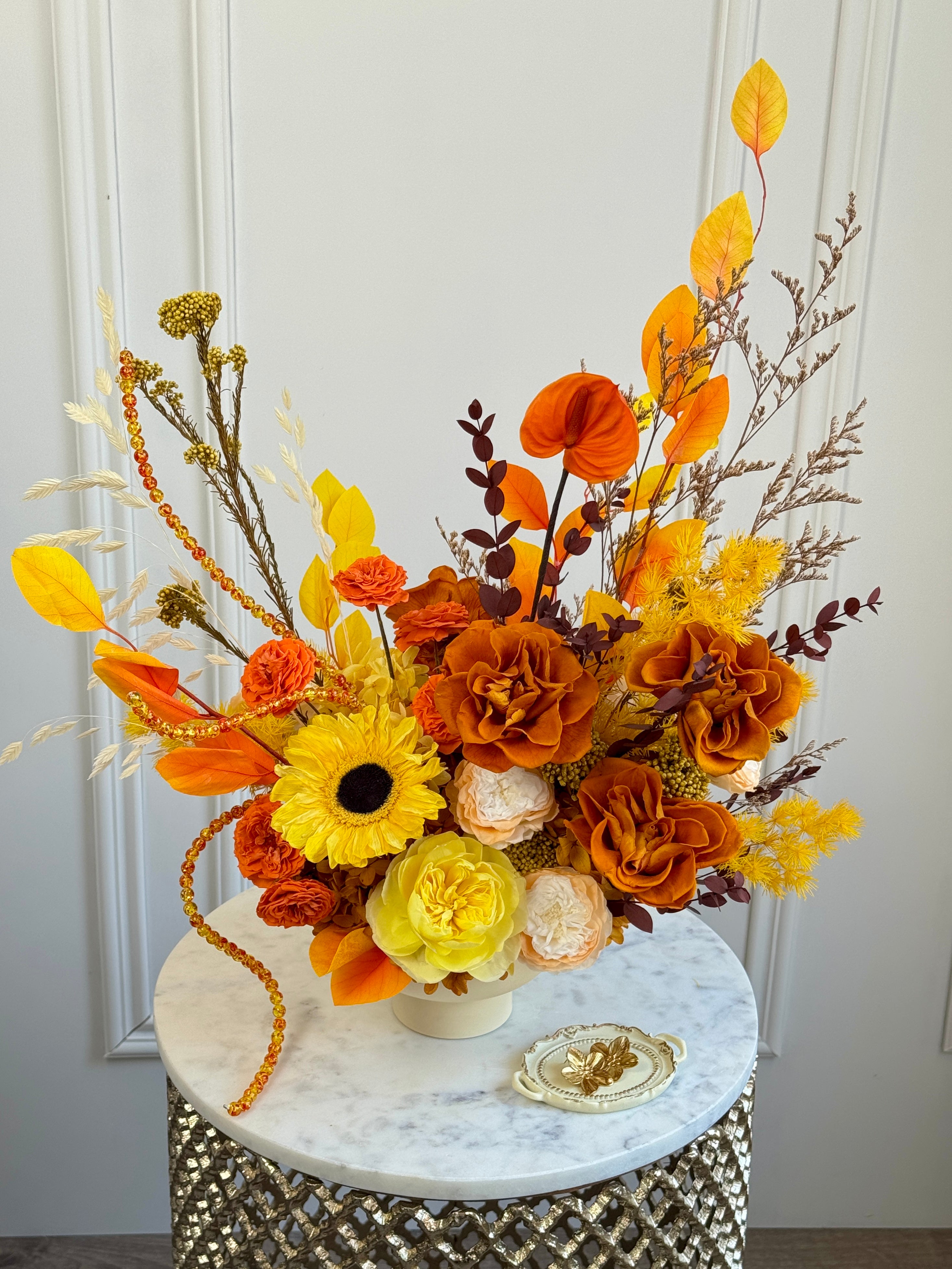 Warm citrus-amber preserved flower arrangement in Los Angeles