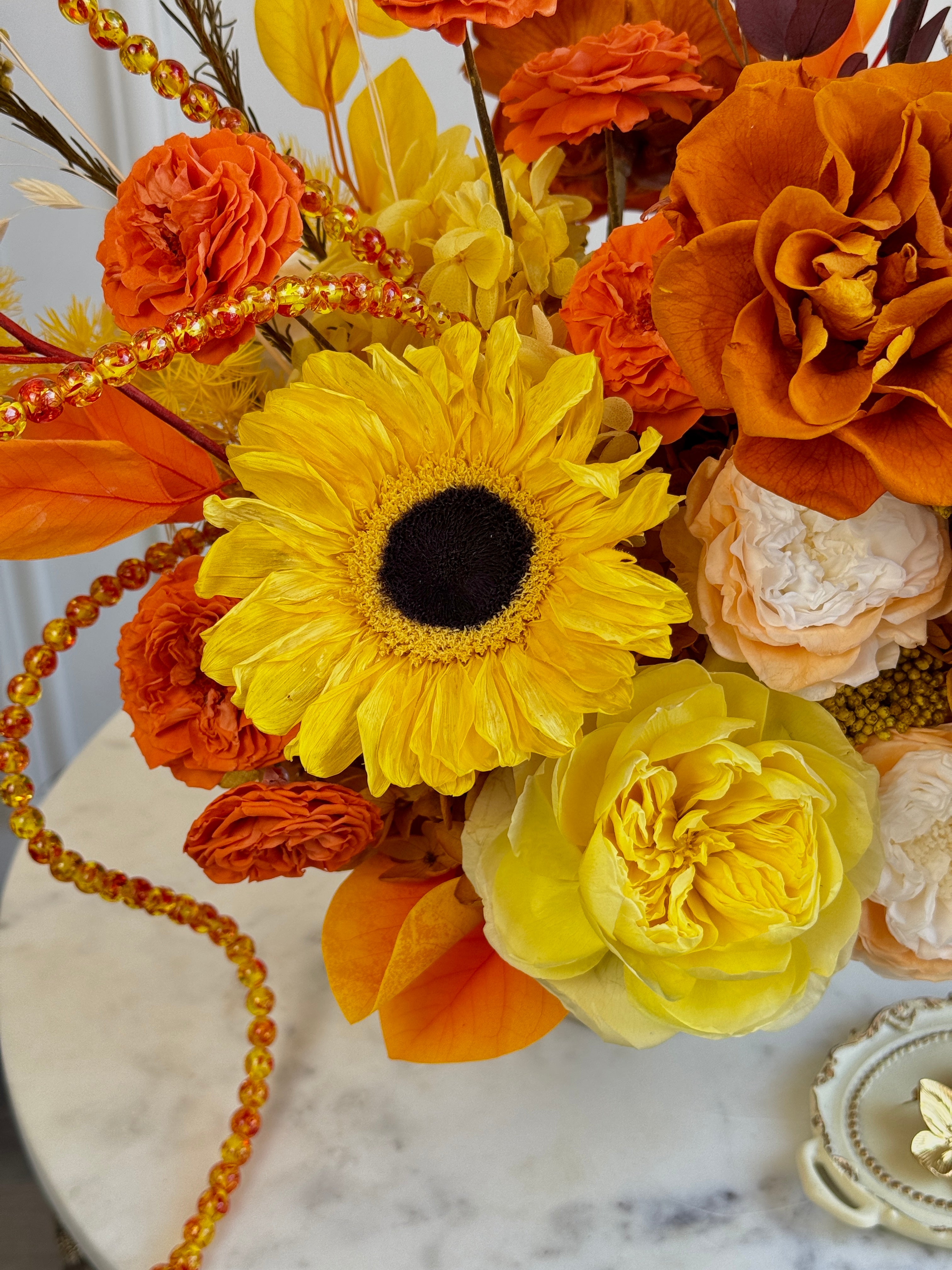 Golden yellow and orange preserved floral design