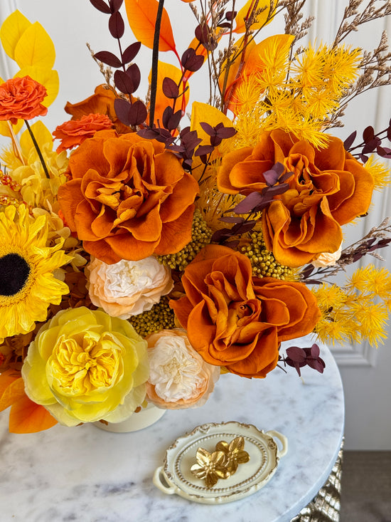 Bright yellow and orange preserved arrangement