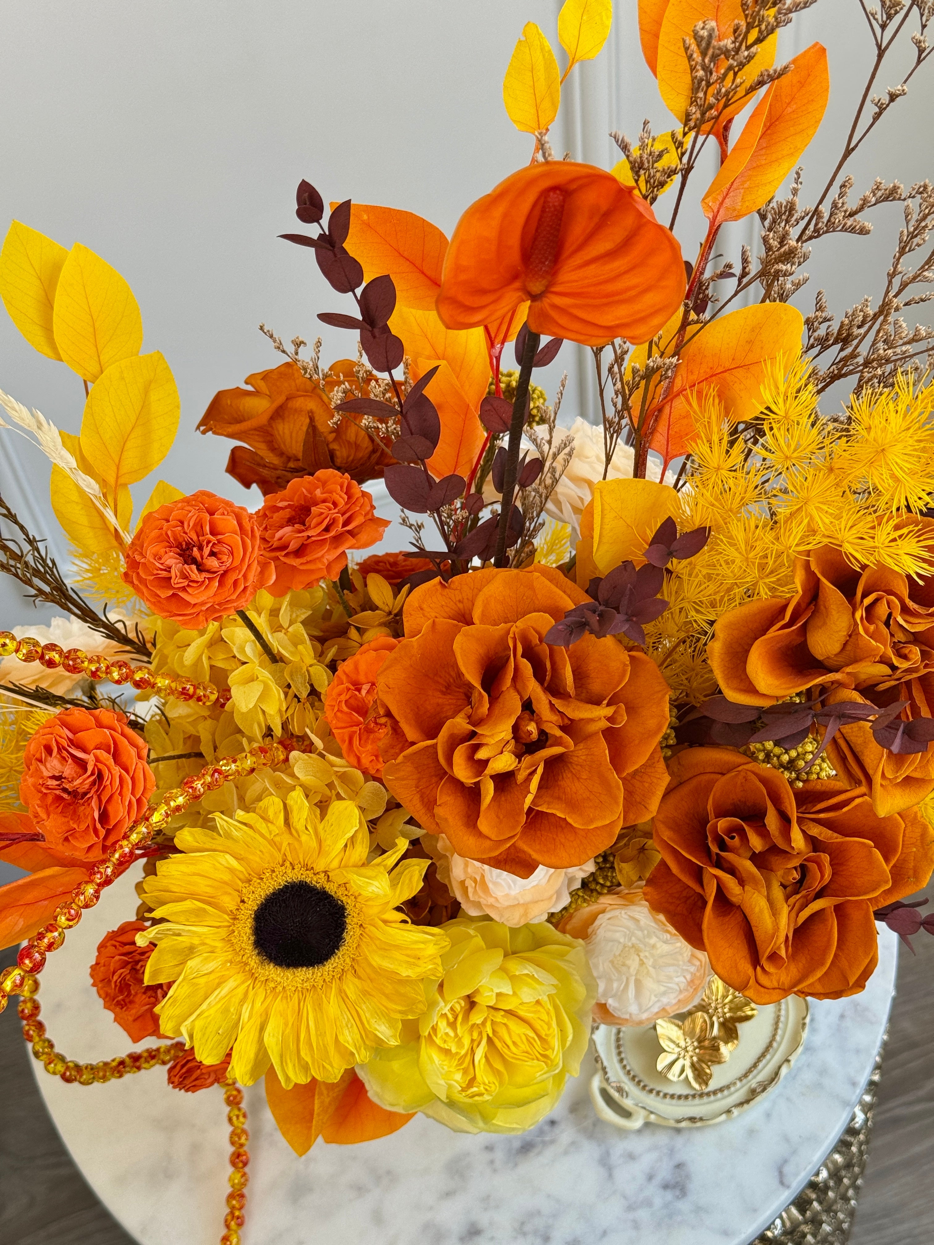 Sunlit preserved flower decoration with amber accents