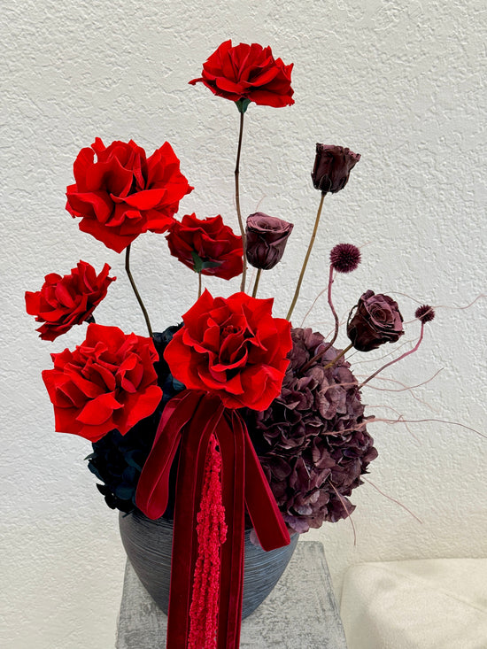 Red and plum preserved roses arrangement with vase