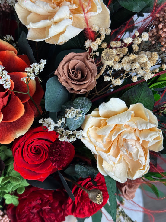Warm burnt orange and burgundy preserved flower arrangement